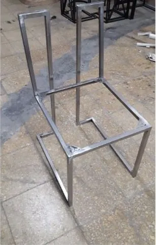 Bare polished stainless bar stool frame before upholstery, showing the cantilever side profile