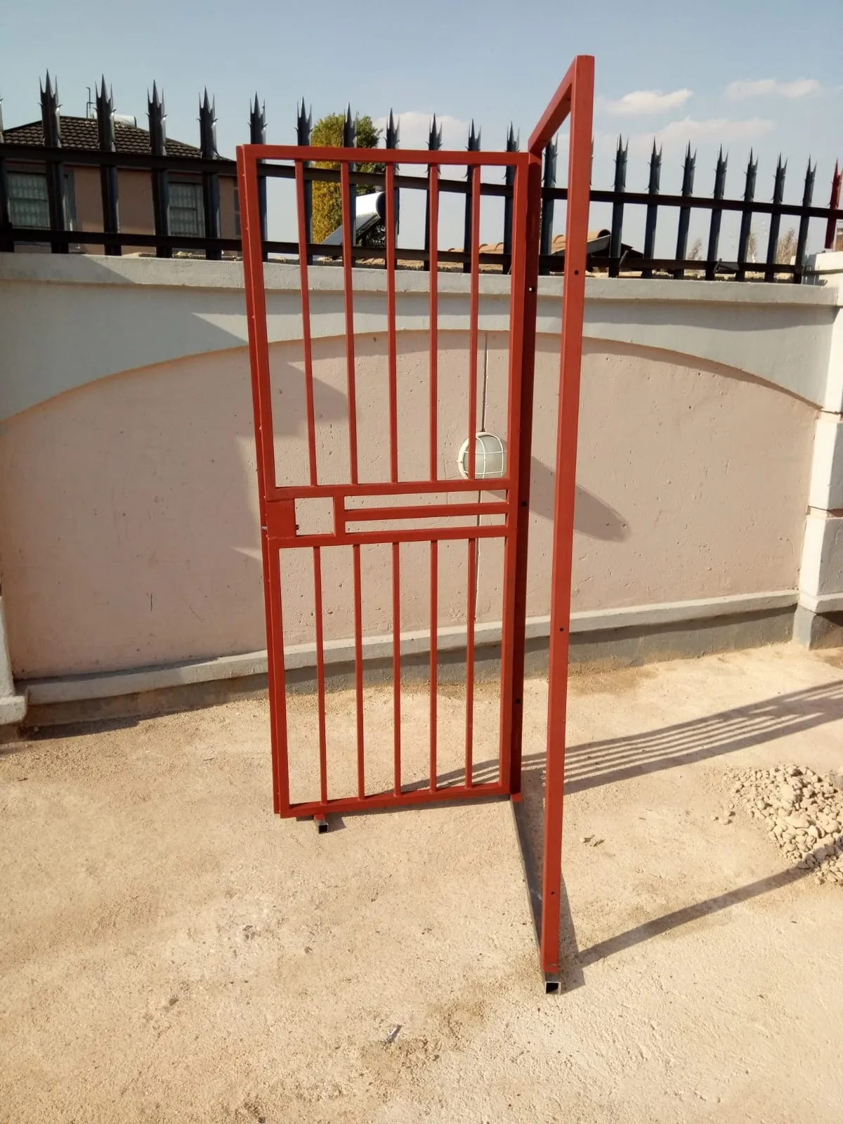Mild steel pedestrian gate in red-oxide primer