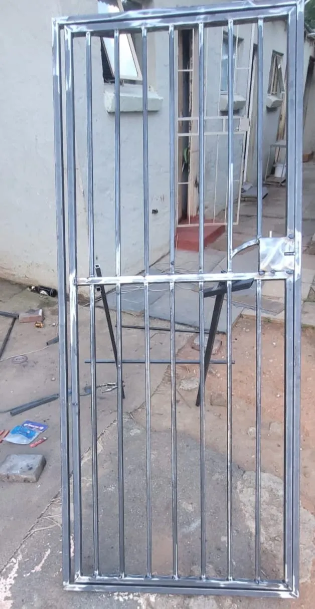 Steel pedestrian gate in the workshop with the welds dressed back bright, before priming